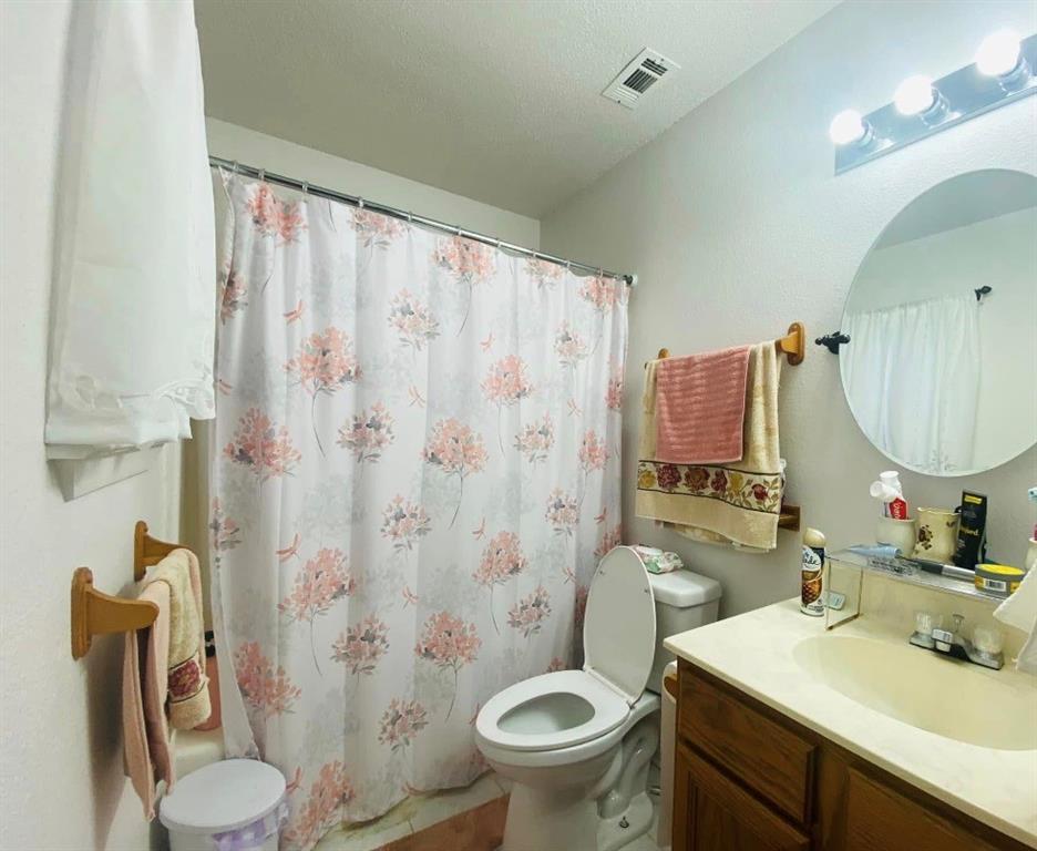 504 Wilson Road Bellmead, TX 76705 - Photo 6 of 12 a bathroom with a sink toilet and shower