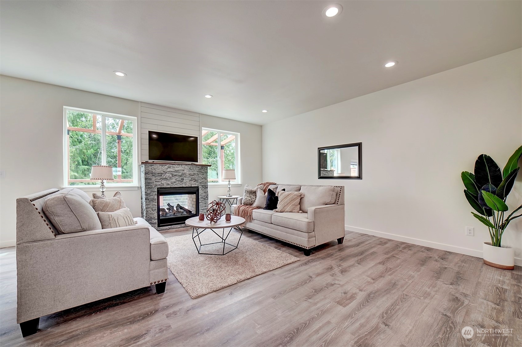 835 Northwest Finn Hill Road Poulsbo, WA 98370 - Photo 12 of 40 a living room with furniture a fireplace and a flat screen tv