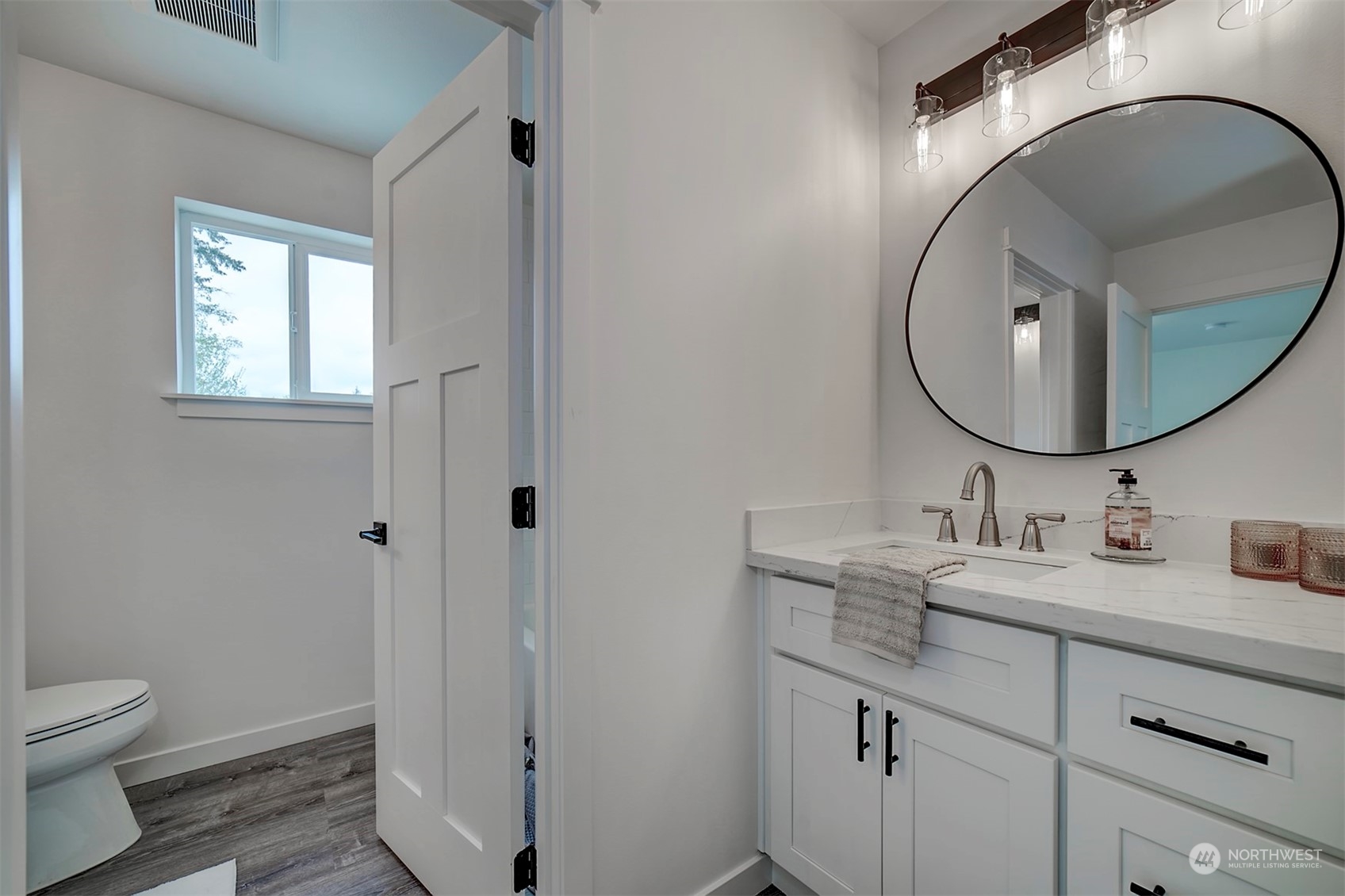 835 Northwest Finn Hill Road Poulsbo, WA 98370 - Photo 18 of 40 a bathroom with a toilet a sink and mirror