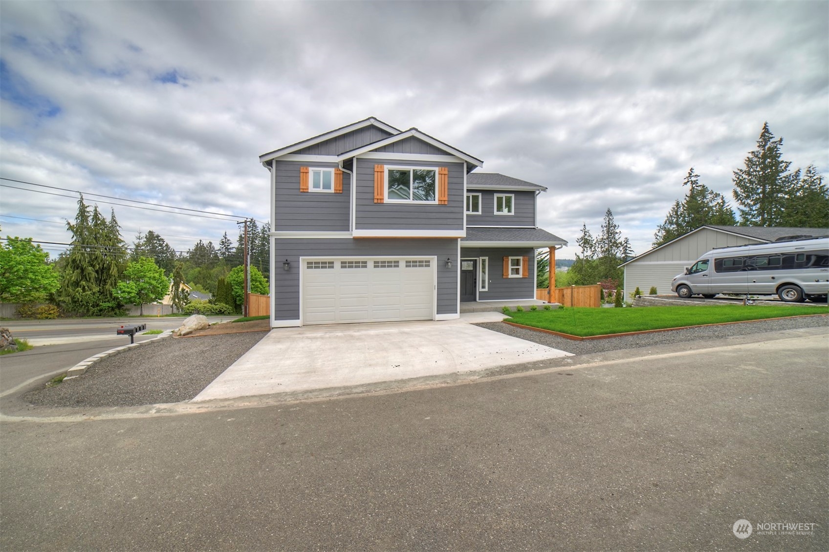 835 Northwest Finn Hill Road Poulsbo, WA 98370 - Photo 2 of 40 a front view of a house with a yard and garage