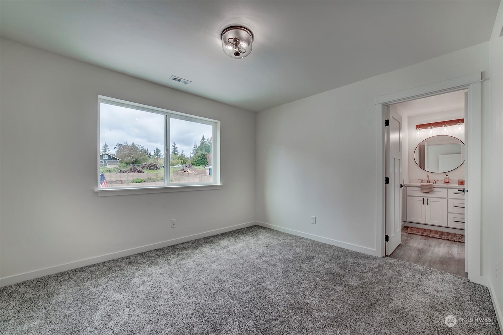835 Northwest Finn Hill Road Poulsbo, WA 98370 - Photo 34 of 40 an empty room with chandelier fan and windows