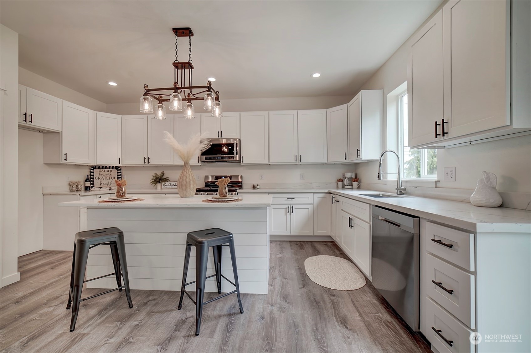 835 Northwest Finn Hill Road Poulsbo, WA 98370 - Photo 6 of 40 a kitchen with a sink white cabinets and stainless steel appliances