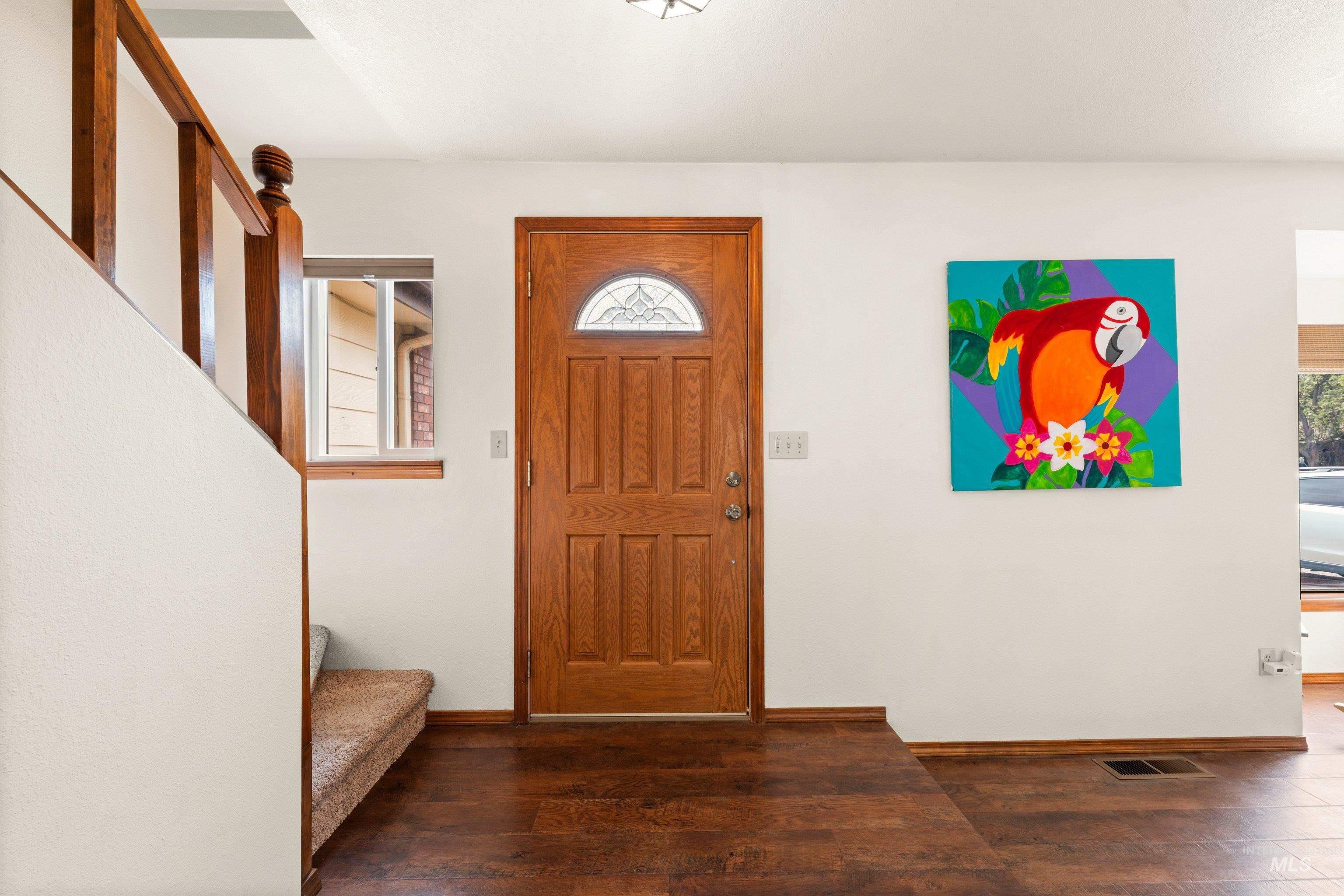 1921 Incline Way Meridian, ID 83646 - Photo 7 of 50 Solid wood-panel entry door with decorative glass insert, wood-finish flooring, and white walls