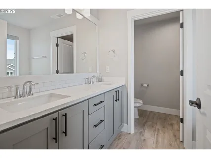 a bathroom with a granite countertop sink mirror and double
