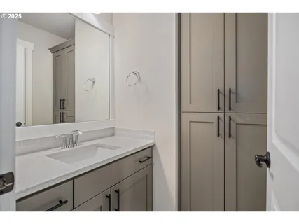 a bathroom with a sink and mirror