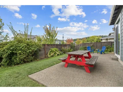 a backyard of a house with table and chairs