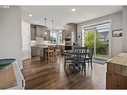a dining room with furniture window and wooden floor