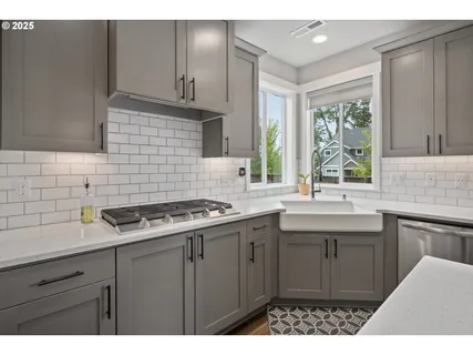 a kitchen with a sink stove and cabinets