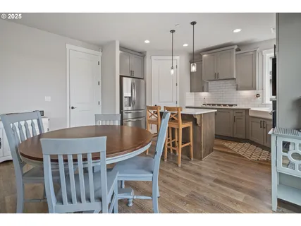 a view of kitchen with cabinets table and chairs