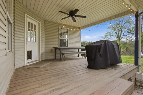 a view of a house with porch and a garden