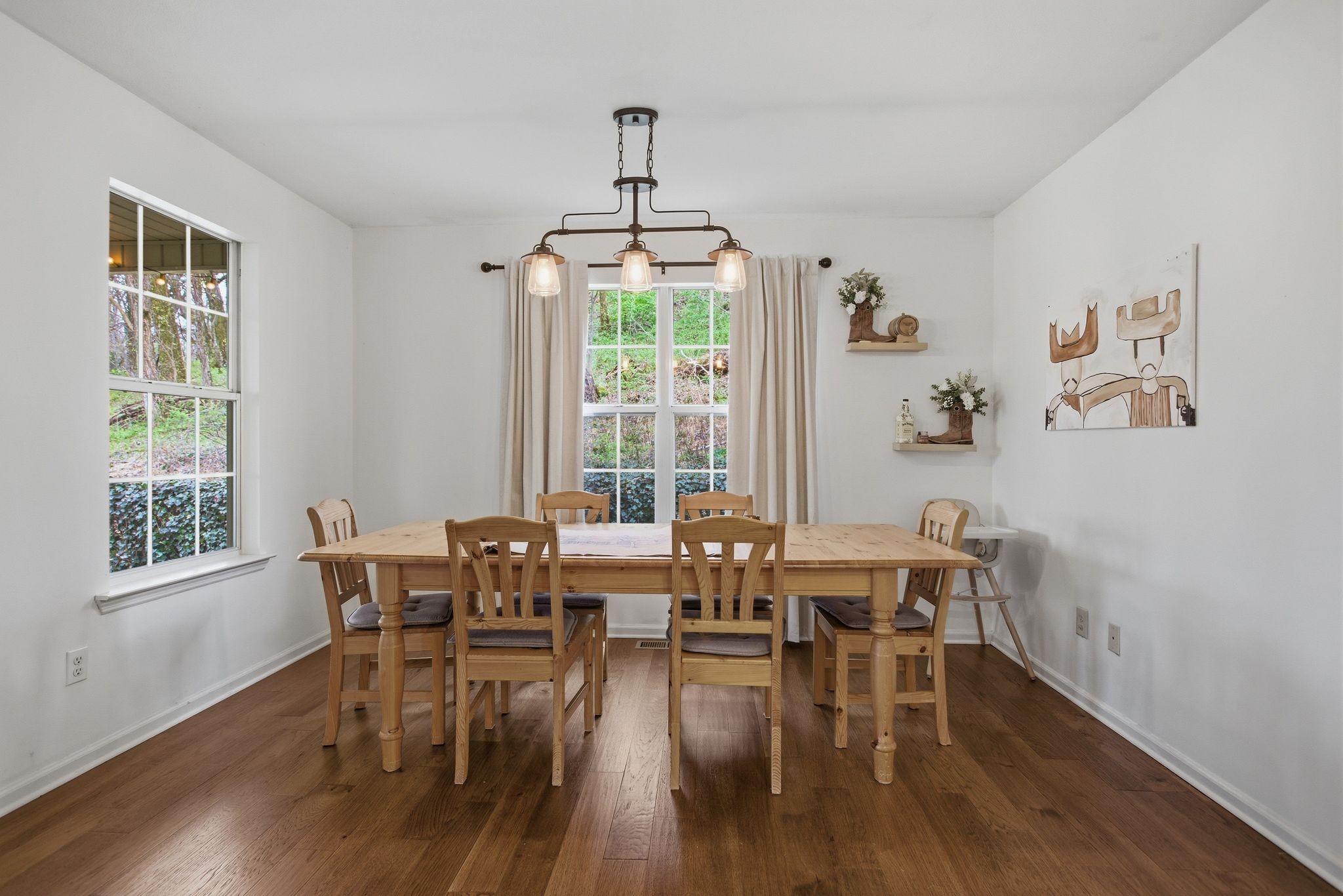 1469 Roy Sellers Road Columbia, TN 38401 - Photo 30 of 55 a dining room with wooden floor a chandelier a glass table and chairs