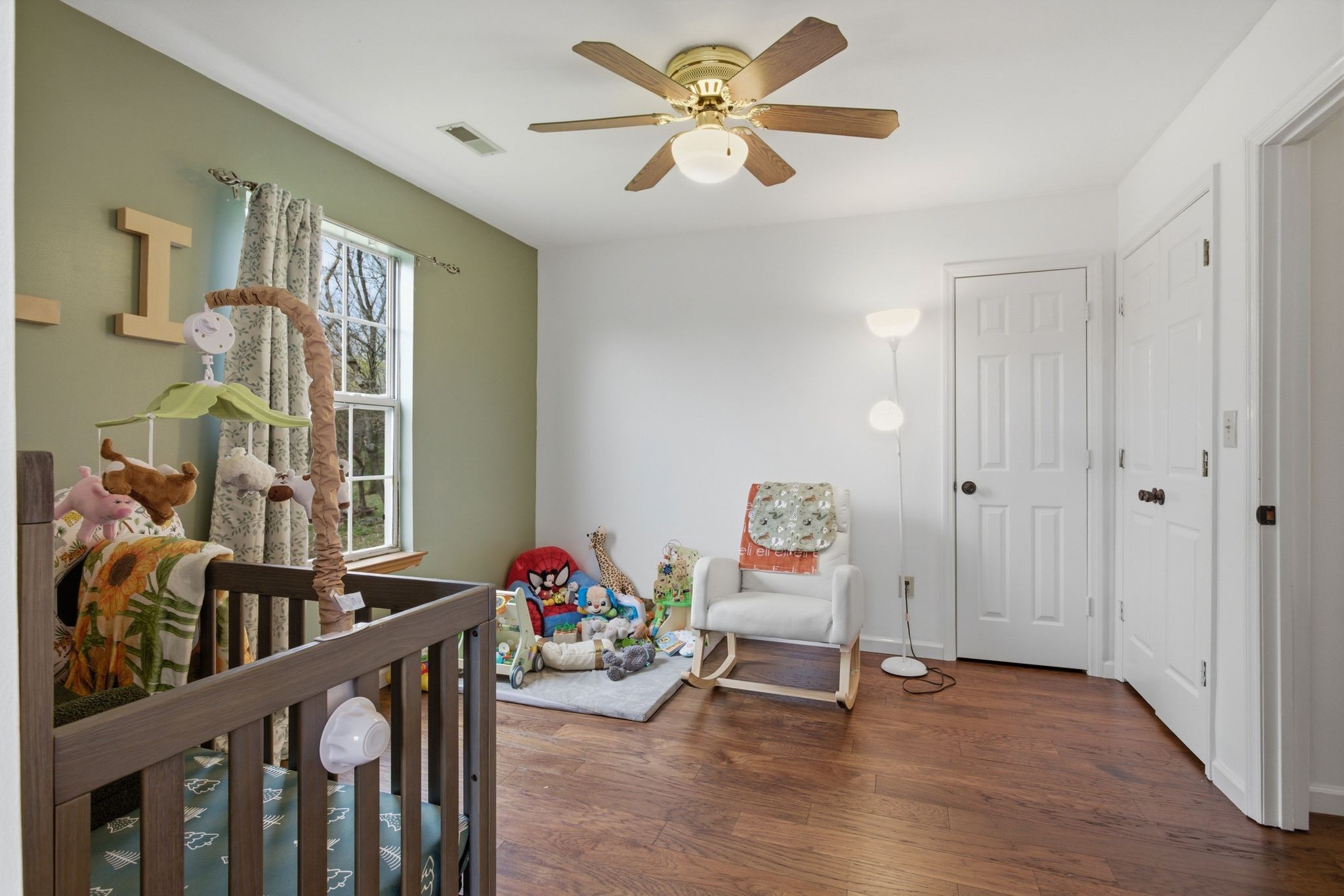 1469 Roy Sellers Road Columbia, TN 38401 - Photo 44 of 55 a view of a livingroom with wooden floor and a ceiling fan