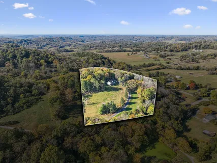 an aerial view of a residential houses with outdoor space and swimming pool