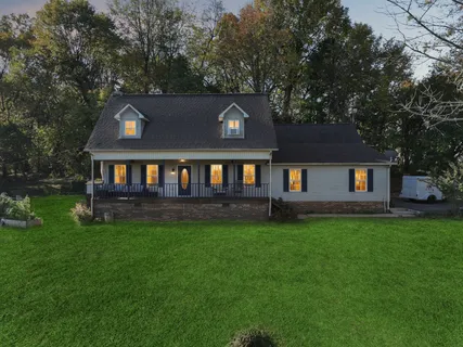 a view of house with a yard