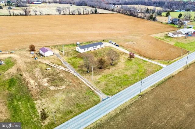 a wooden bench sitting in the middle of a yard