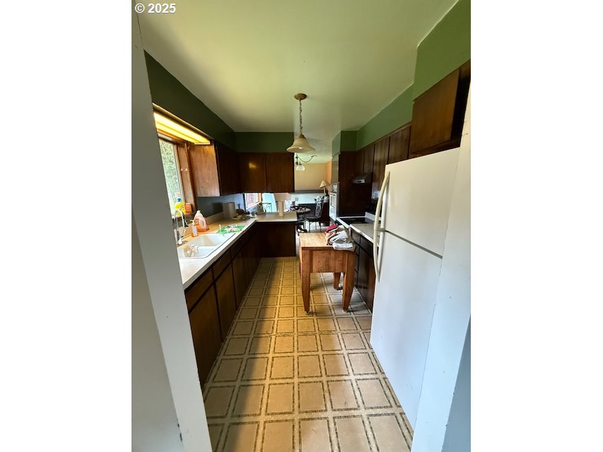 101 Brooks Road Carson, WA 98610 - Photo 10 of 16 a kitchen with a sink and a refrigerator