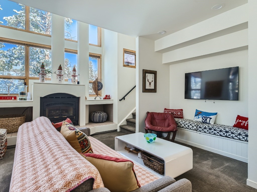 2017 Soda Ridge Road, Unit 1939 Keystone, CO 80435 - Photo 5 of 27 a living room with furniture a flat screen tv and a fireplace