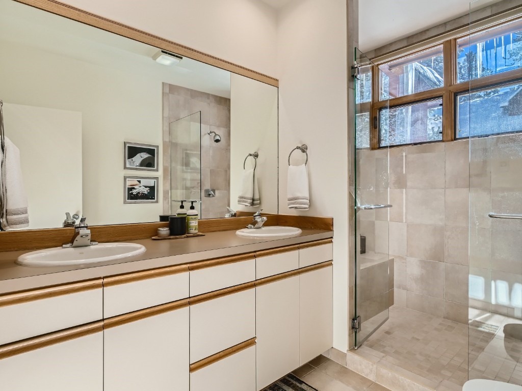 2017 Soda Ridge Road, Unit 1939 Keystone, CO 80435 - Photo 10 of 27 a bathroom with a granite countertop sink and a mirror