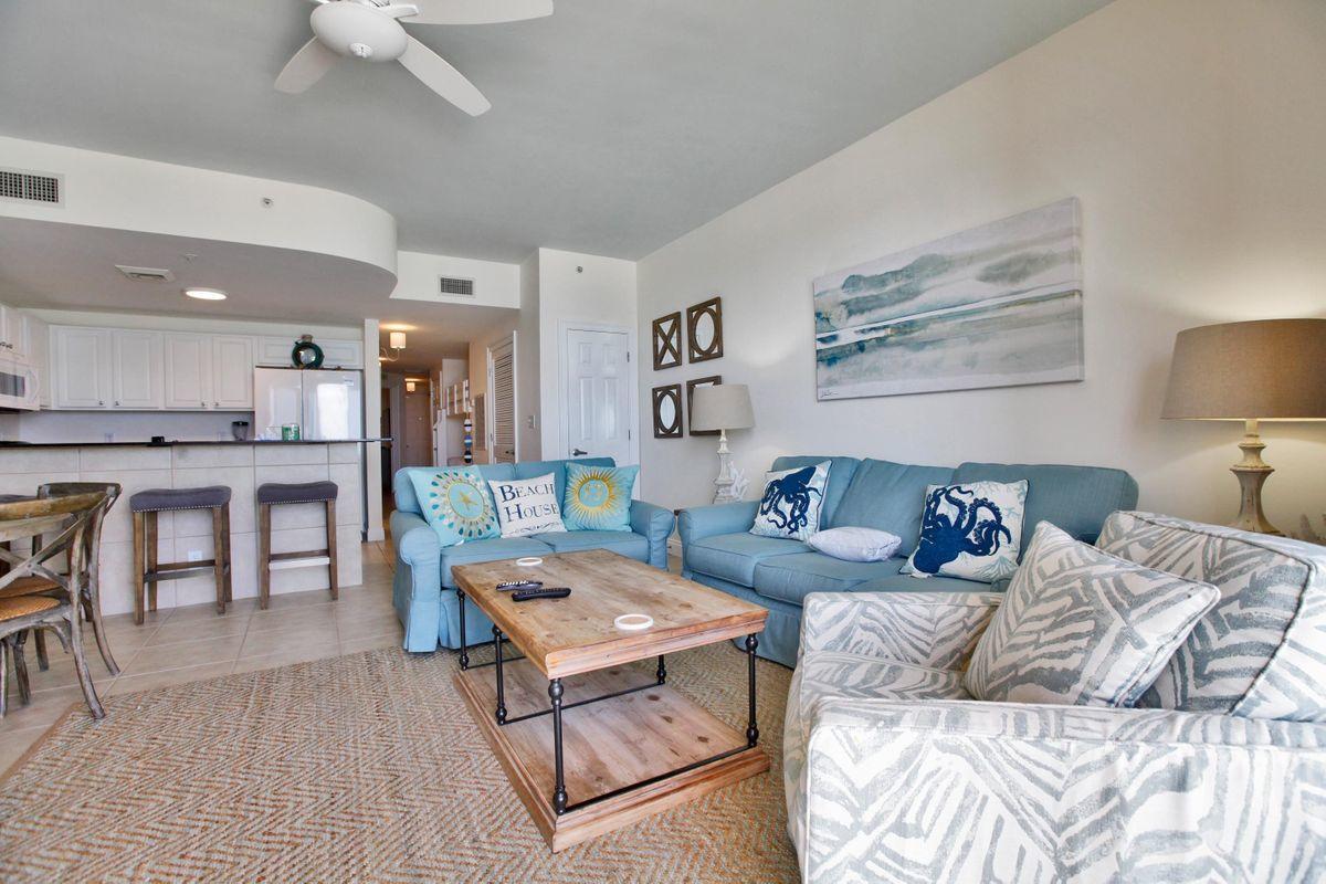 15817 Front Beach Road, Unit 407W Panama City Beach, FL 32413 - Photo 1 of 23 a living room with furniture and a table