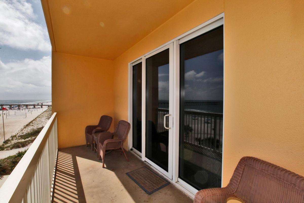 15817 Front Beach Road, Unit 407W Panama City Beach, FL 32413 - Photo 14 of 23 a balcony with chairs and a stove