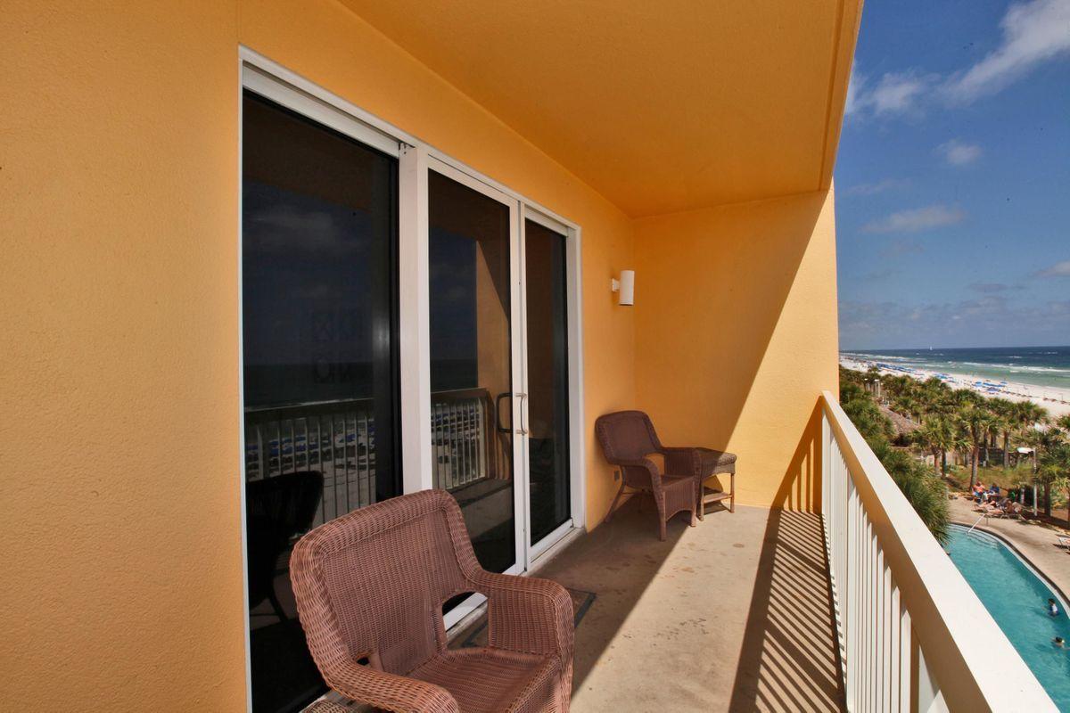 15817 Front Beach Road, Unit 407W Panama City Beach, FL 32413 - Photo 15 of 23 a balcony with table and chairs