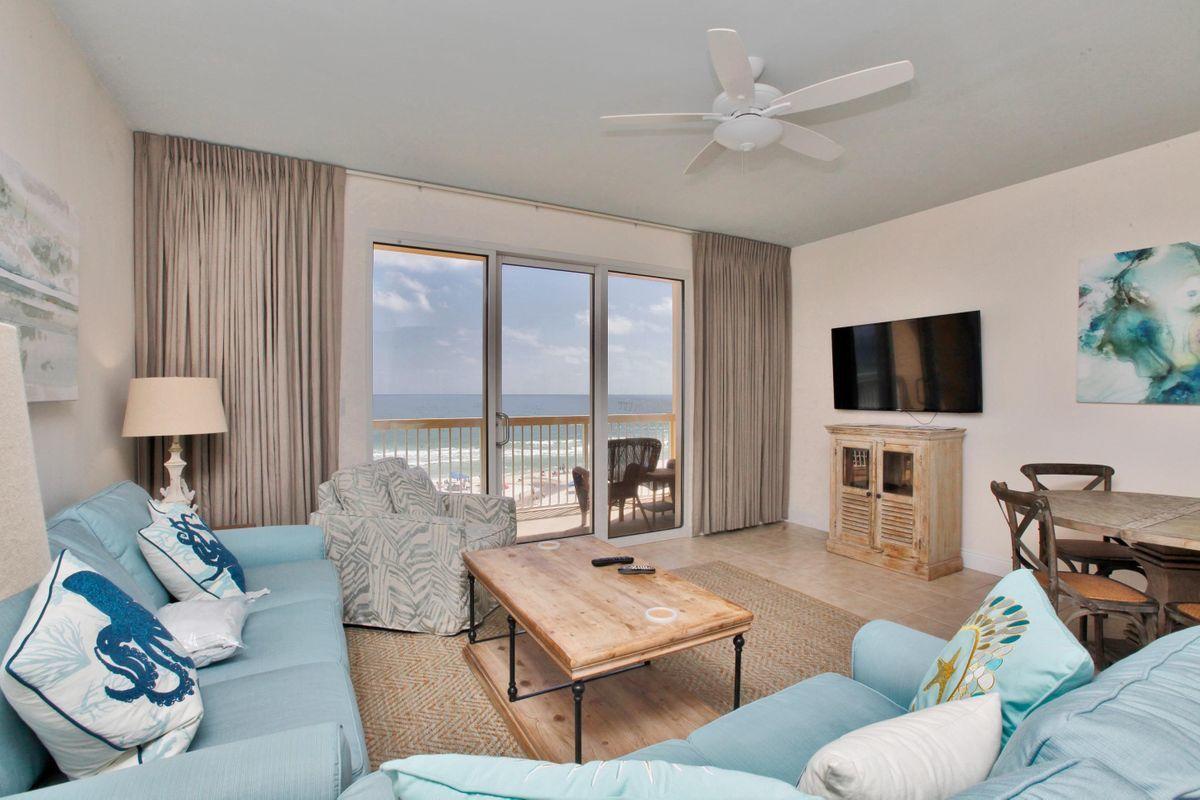 15817 Front Beach Road, Unit 407W Panama City Beach, FL 32413 - Photo 3 of 23 a living room with furniture a large window and a flat screen tv