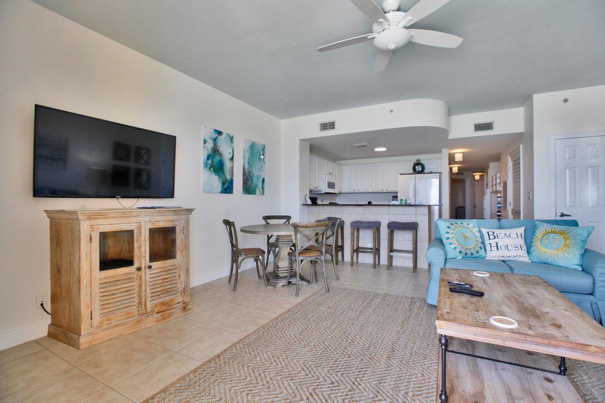 15817 Front Beach Road, Unit 407W Panama City Beach, FL 32413 - Photo 4 of 23 a living room with furniture and a flat screen tv
