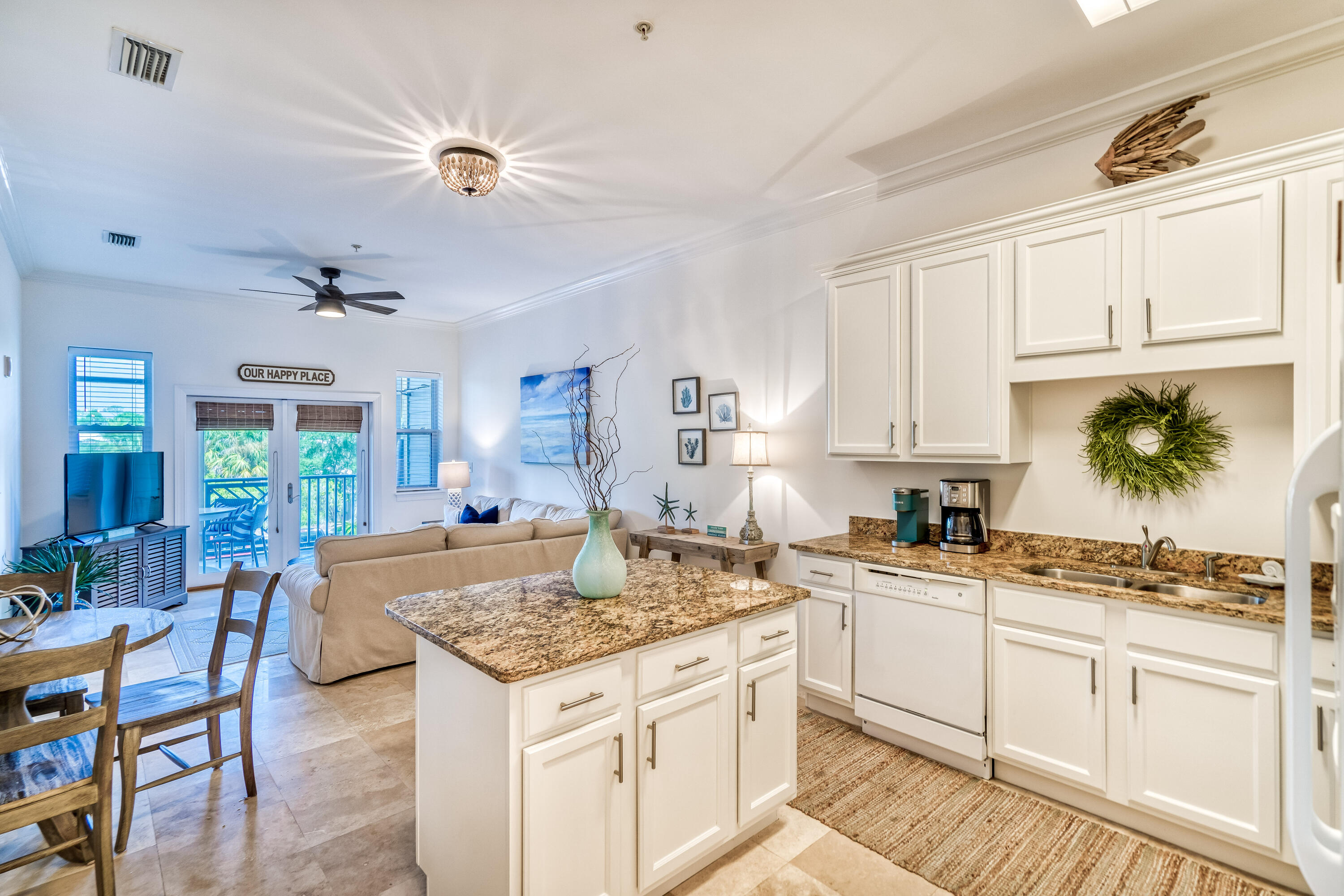 231 Somerset Bridge Road, Unit 1207 Santa Rosa Beach, FL 32459 - Photo 11 of 48 a kitchen with a stove a sink dishwasher and white cabinets with wooden floor