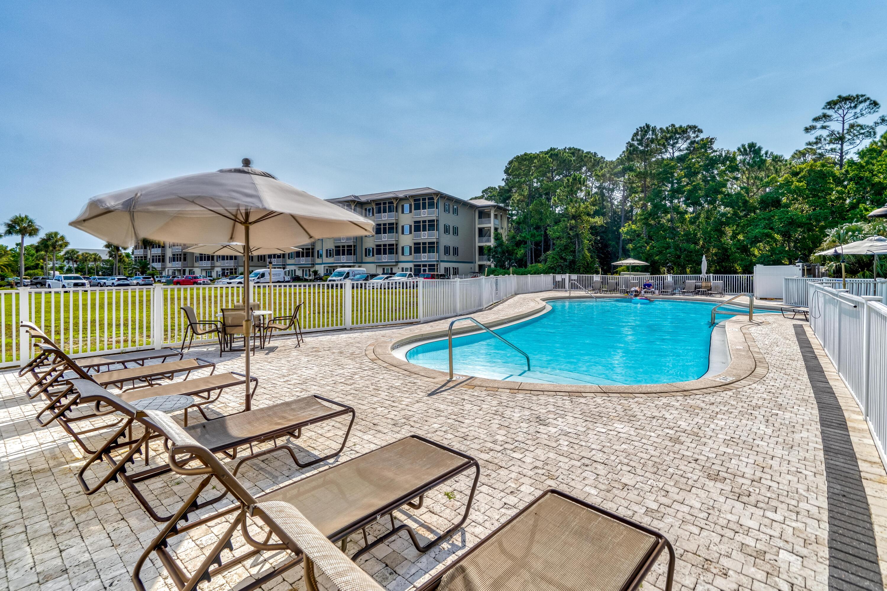 231 Somerset Bridge Road, Unit 1207 Santa Rosa Beach, FL 32459 - Photo 42 of 48 a view of a swimming pool with lounge chairs