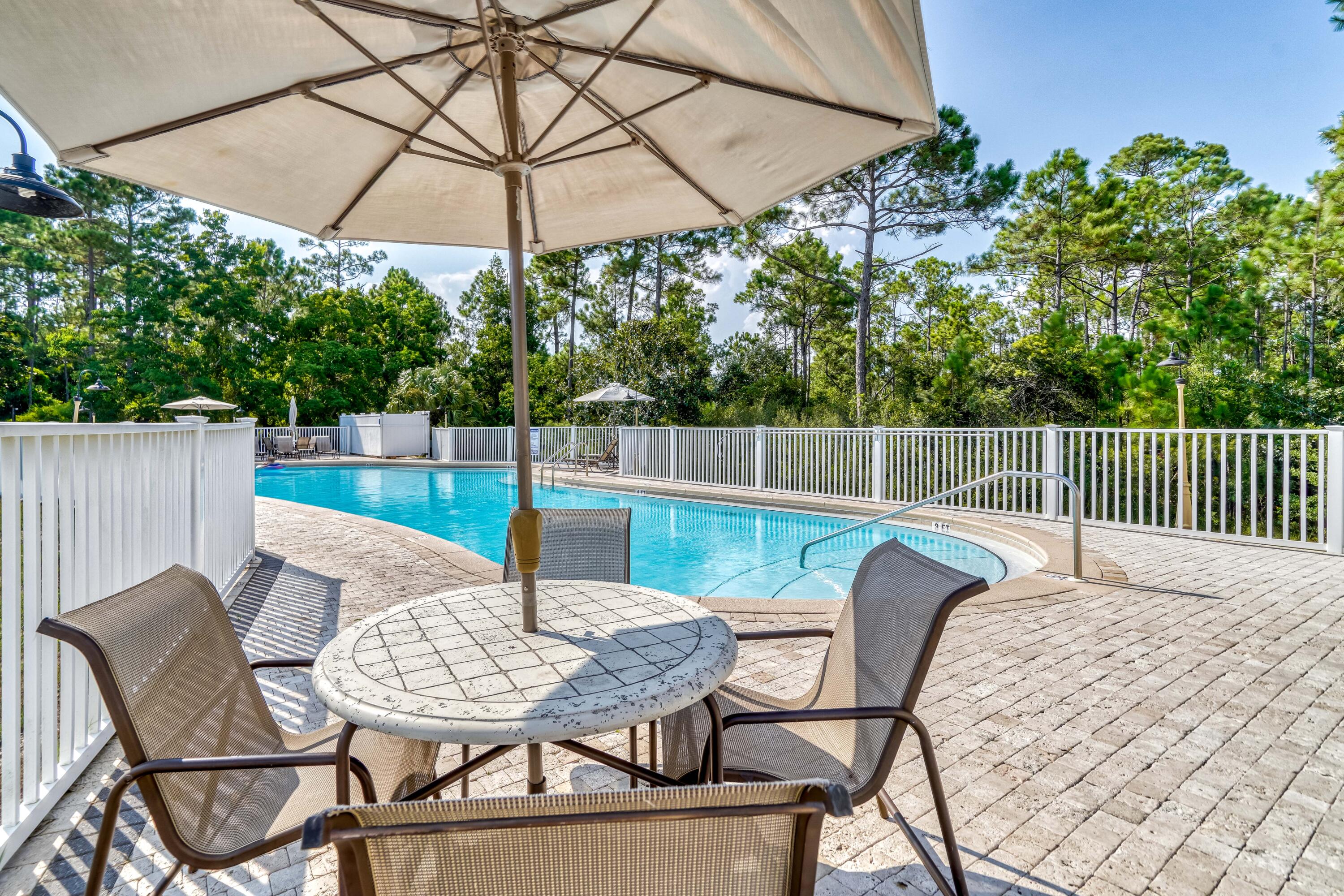 231 Somerset Bridge Road, Unit 1207 Santa Rosa Beach, FL 32459 - Photo 44 of 48 a view of a chairs and table in the back yard
