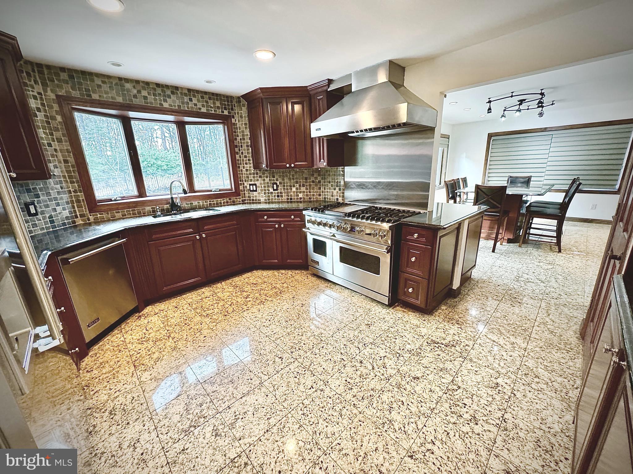 54 Las Brisas Boulevard Voorhees, NJ 08043 - Photo 21 of 67 a kitchen with stainless steel appliances granite countertop a stove a sink and a microwave