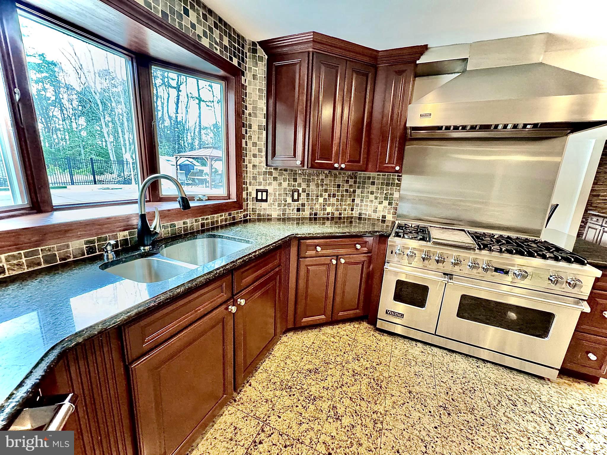 54 Las Brisas Boulevard Voorhees, NJ 08043 - Photo 22 of 67 a kitchen with stainless steel appliances granite countertop a stove a sink and a microwave