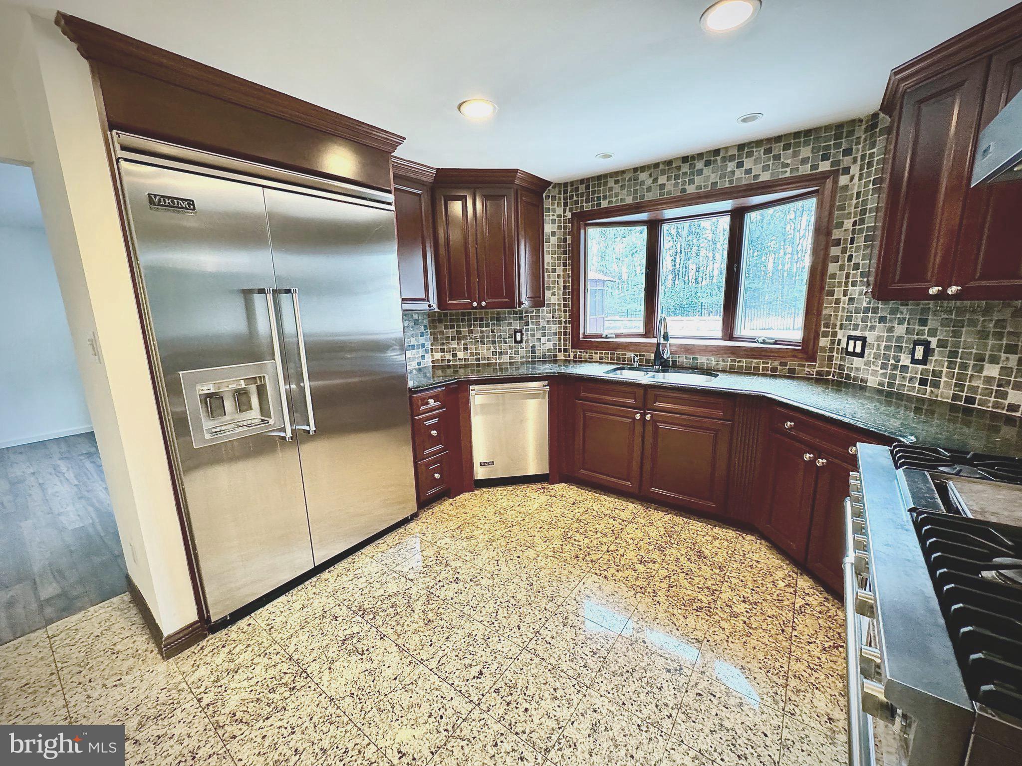 54 Las Brisas Boulevard Voorhees, NJ 08043 - Photo 24 of 67 a kitchen with stainless steel appliances granite countertop a sink stove and refrigerator