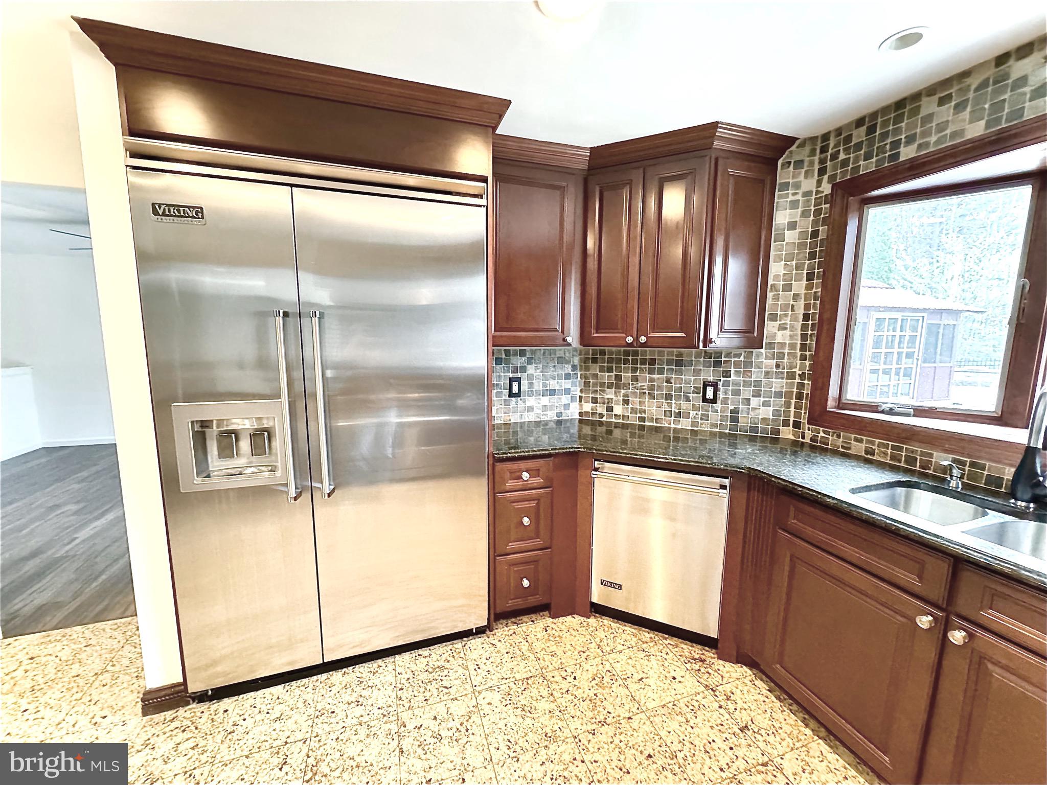 54 Las Brisas Boulevard Voorhees, NJ 08043 - Photo 25 of 67 a kitchen with stainless steel appliances granite countertop a refrigerator a sink and white cabinets