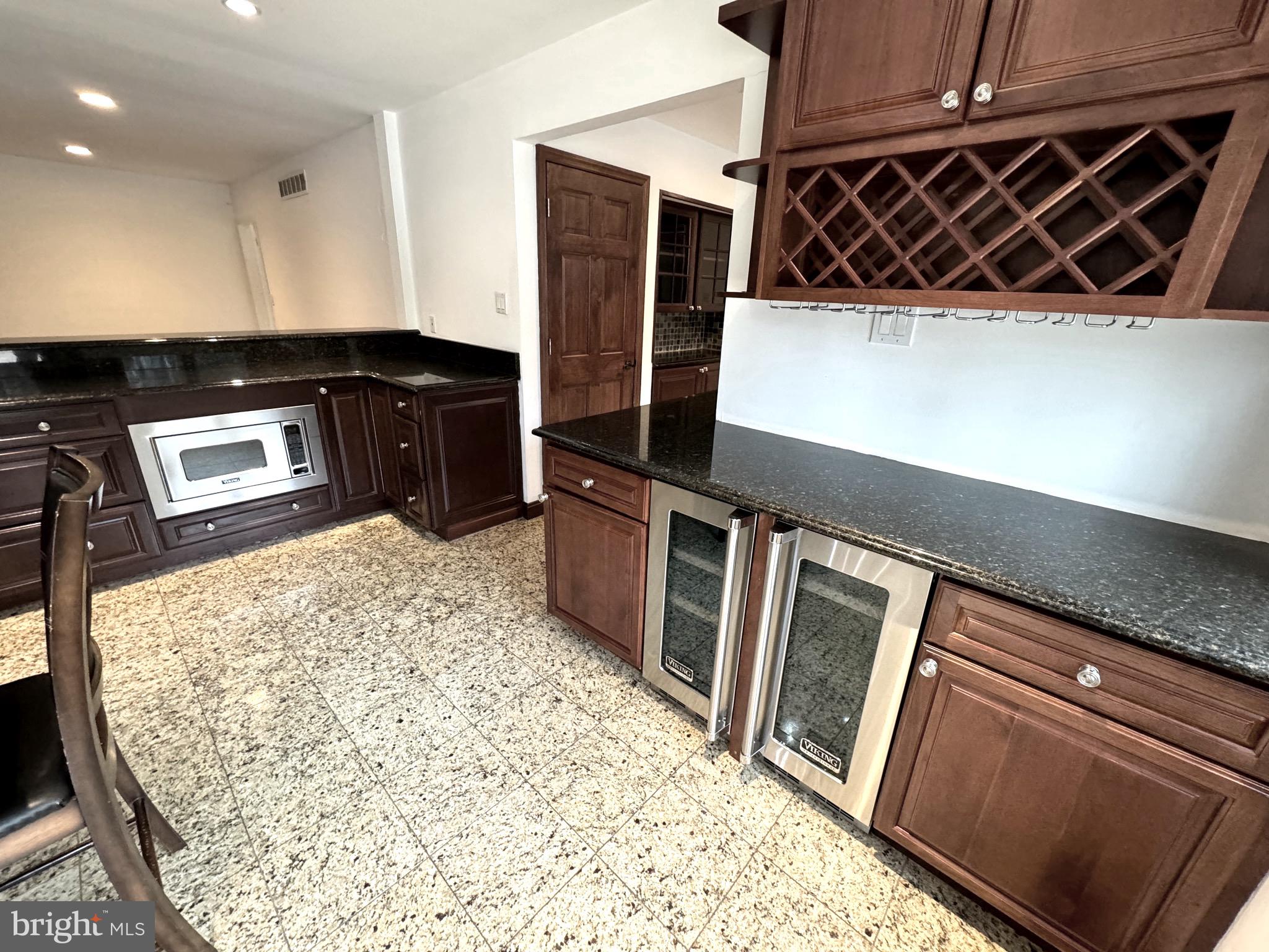 54 Las Brisas Boulevard Voorhees, NJ 08043 - Photo 29 of 67 a kitchen with wooden cabinets and a stove top oven
