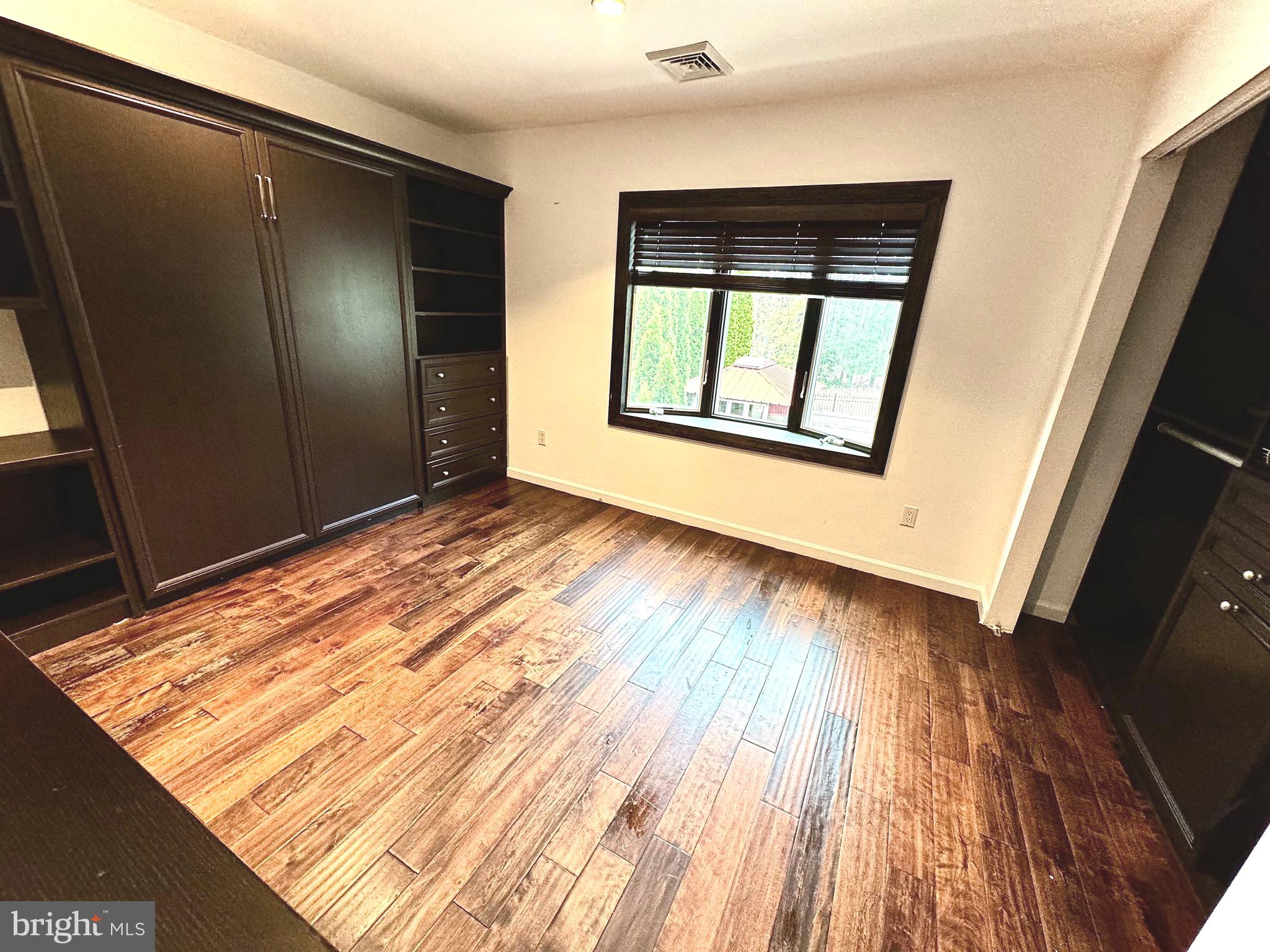 54 Las Brisas Boulevard Voorhees, NJ 08043 - Photo 46 of 67 a view of an empty room with wooden floor and a window