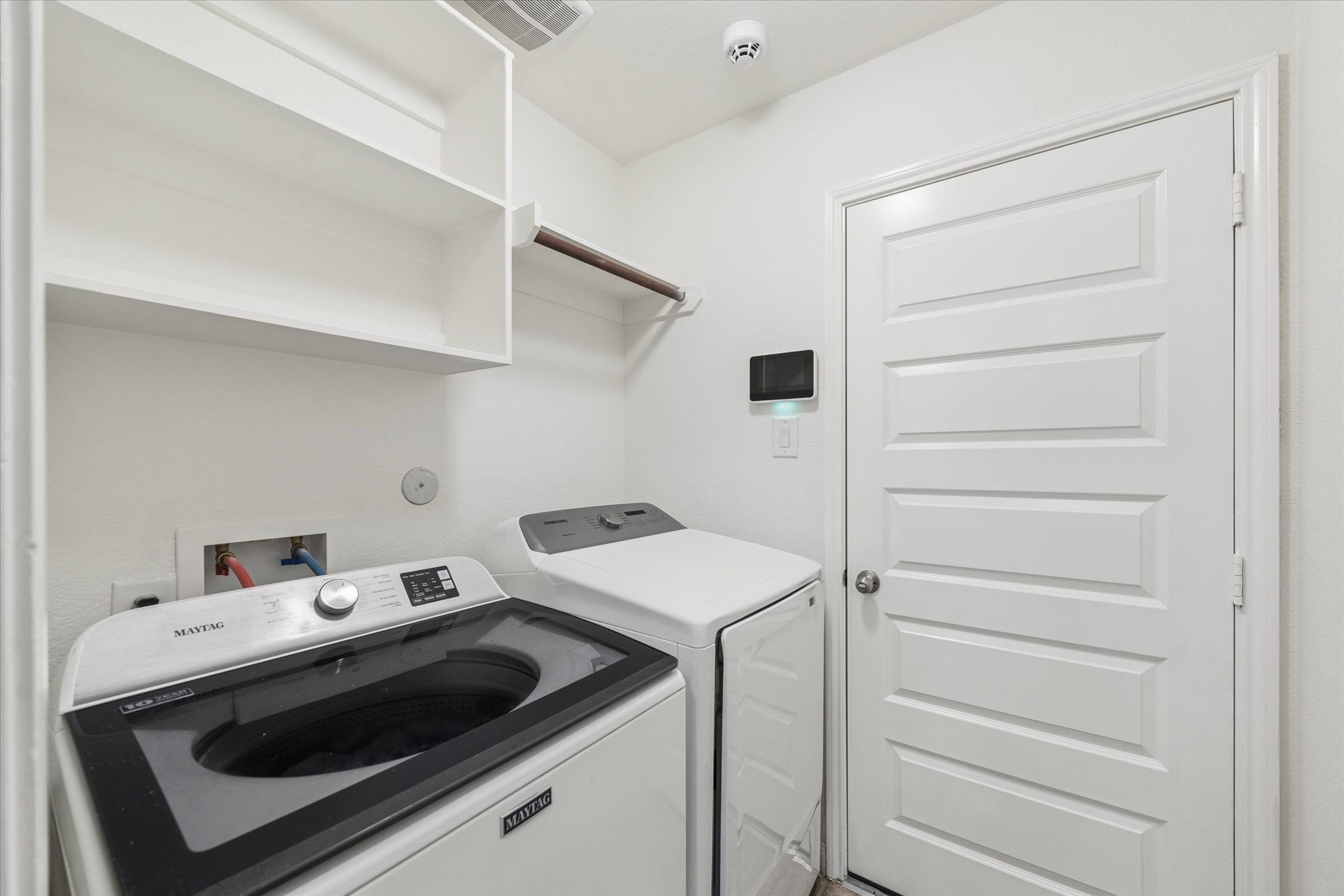 7015 Riata Hills Lane Spring, TX 77379 - Photo 27 of 33 A conveniently located laundry room between the kitchen and garage, recently painted to offer a fresh and well-maintained feel.