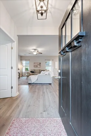 a living room with stainless steel appliances furniture a rug and a window
