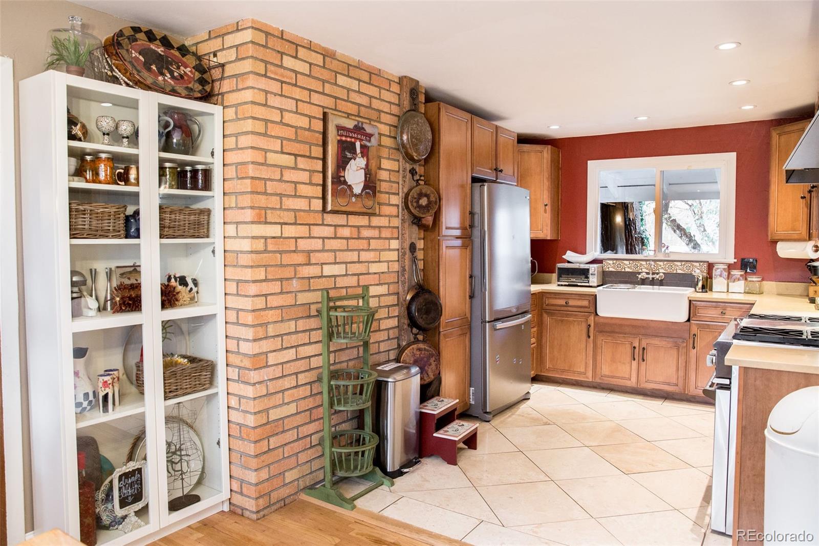 983 Cherryvale Road Boulder, CO 80303 - Photo 12 of 36 a kitchen with refrigerator cabinets and window