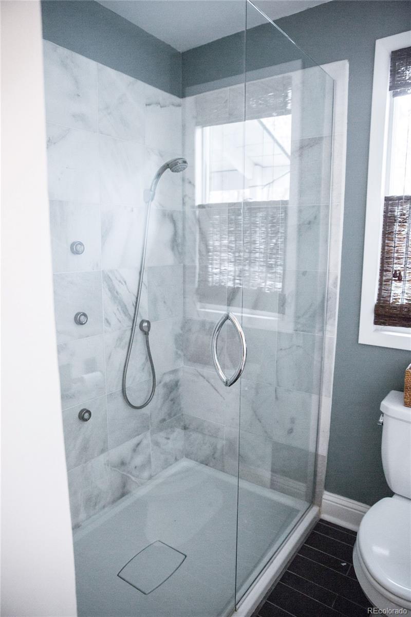 983 Cherryvale Road Boulder, CO 80303 - Photo 30 of 36 a bathroom with a glass shower door