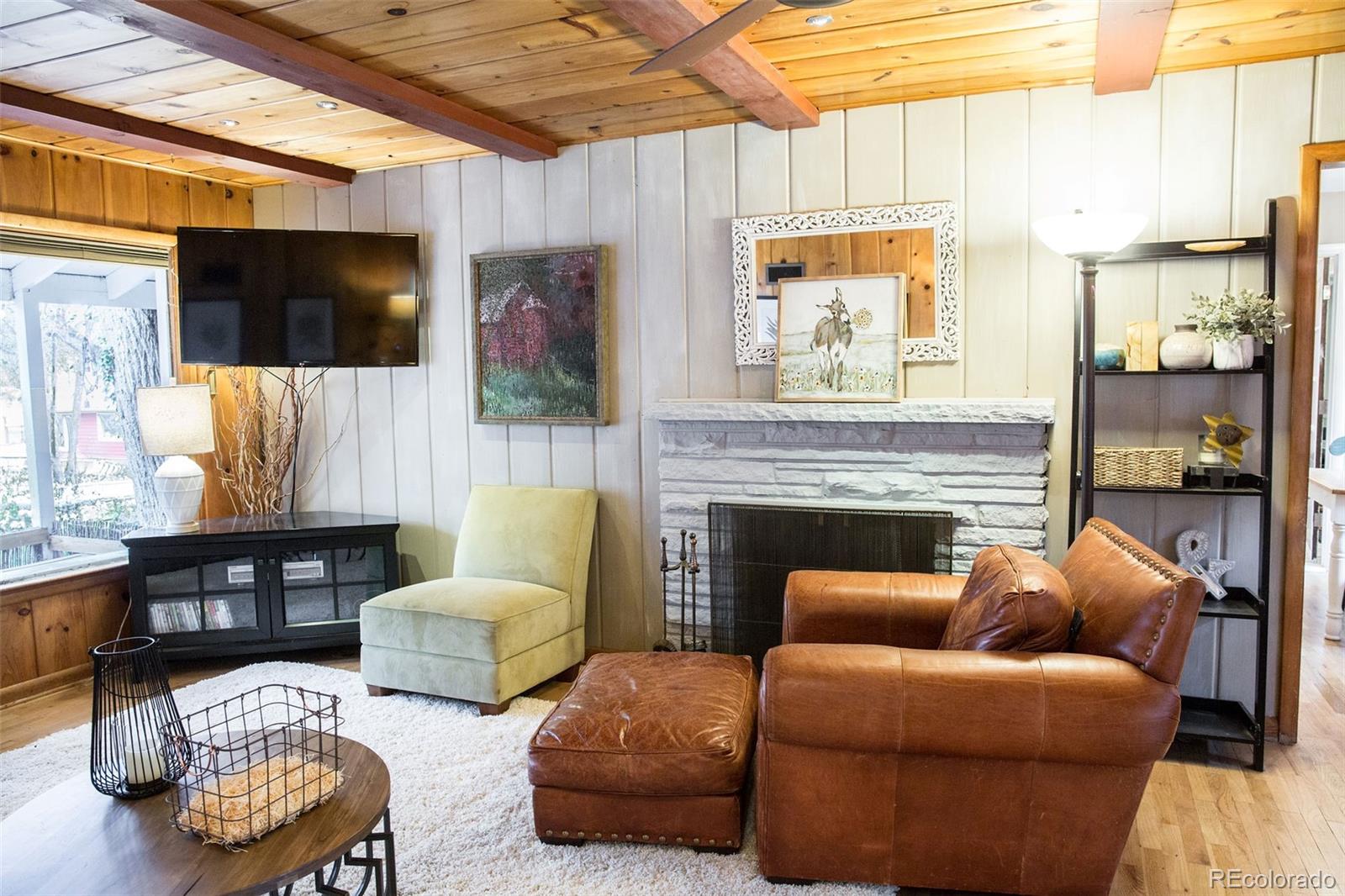 983 Cherryvale Road Boulder, CO 80303 - Photo 6 of 36 a living room with furniture a flat screen tv and a fireplace
