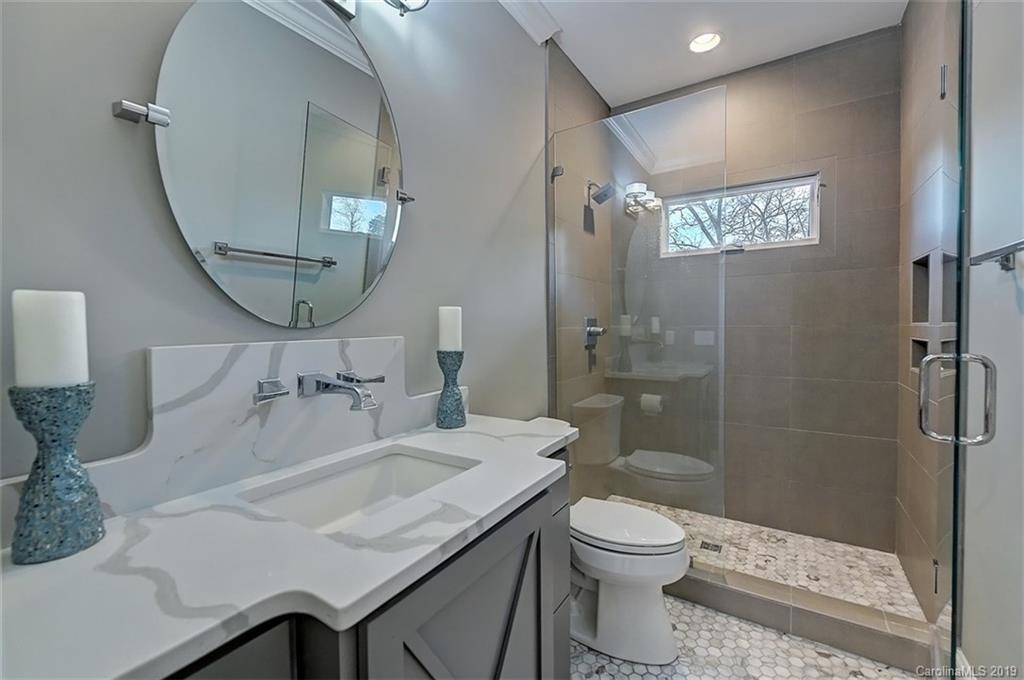 188 Chatham Road Mooresville, NC 28117 - Photo 31 of 48 a bathroom with a granite countertop toilet a sink and a mirror