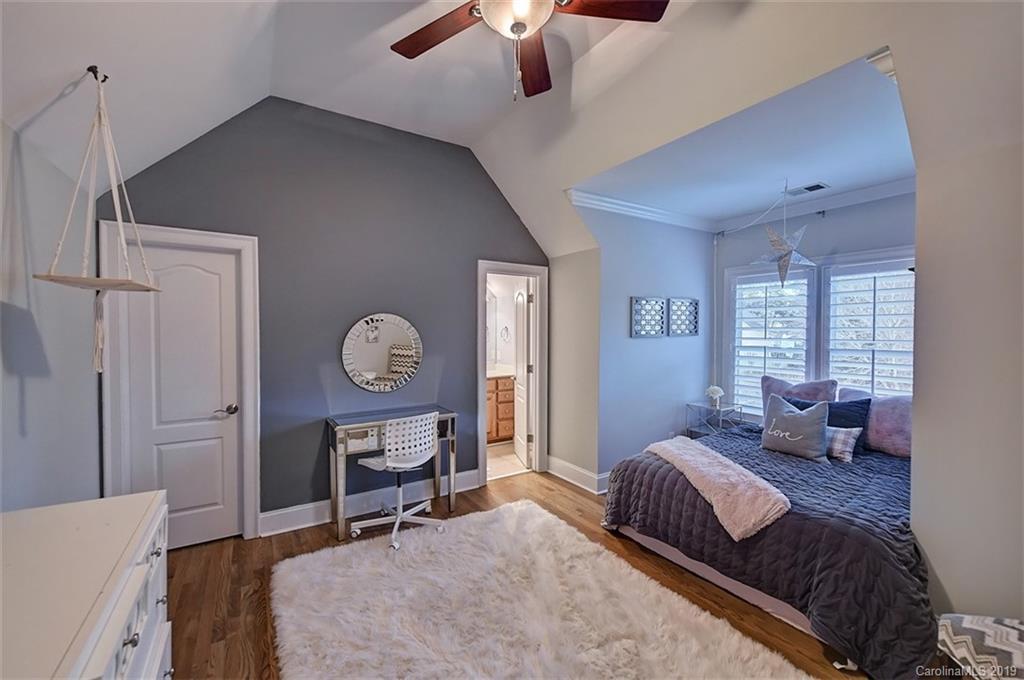 188 Chatham Road Mooresville, NC 28117 - Photo 32 of 48 a bedroom with a bed window and a chandelier