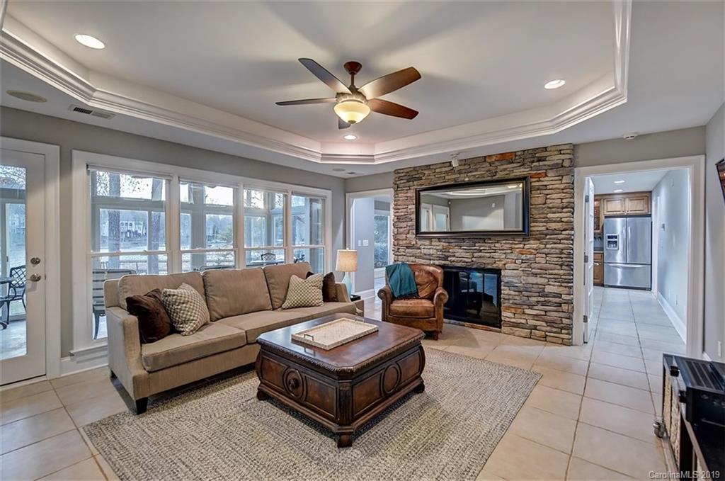 188 Chatham Road Mooresville, NC 28117 - Photo 34 of 48 a living room with furniture a fireplace and a flat screen tv