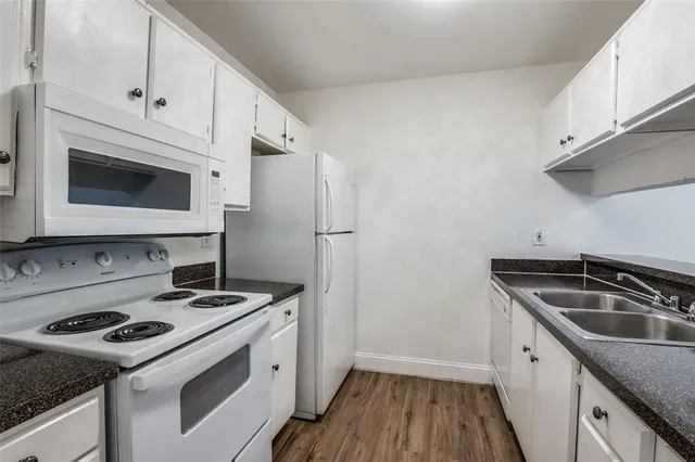 a kitchen with a sink stove and microwave