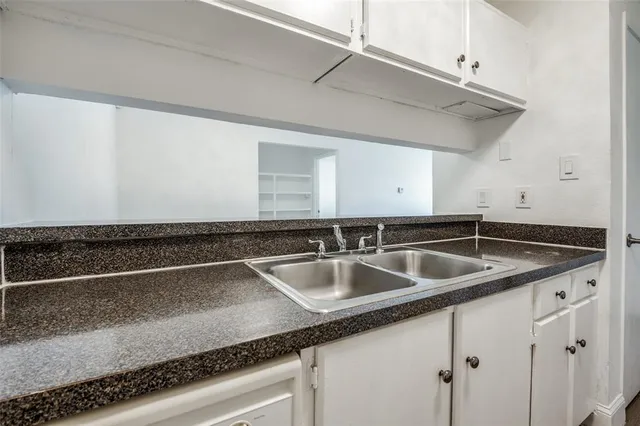 a kitchen with a sink and cabinets