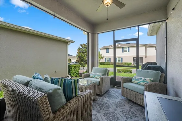 a front view of a house with a yard and potted plants