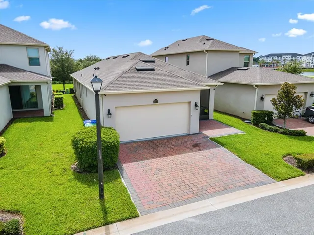 a view of a dining room with furniture large windows and wooden floor