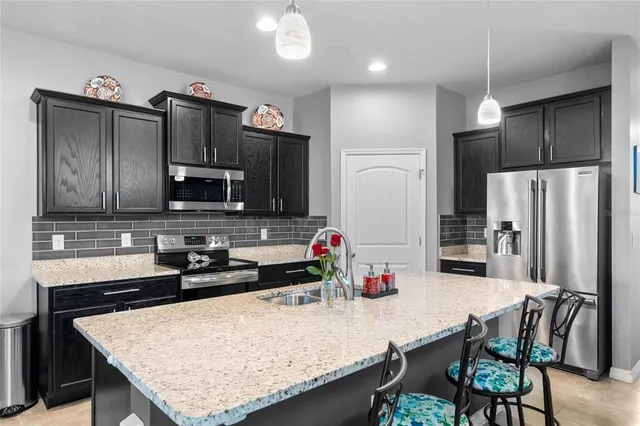 a bedroom with a bed and a lamp on dresser