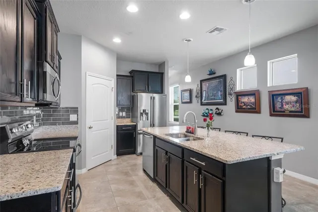 a bathroom with a granite countertop shower a sink and a mirror